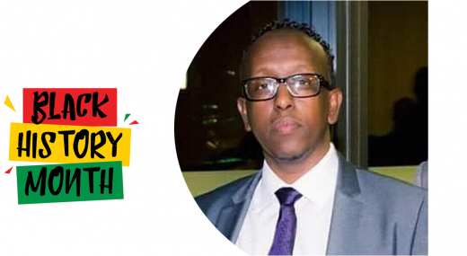 Black History Month logo and to the right photograph of Abdulkadir wearing spectacles and a suit and tie