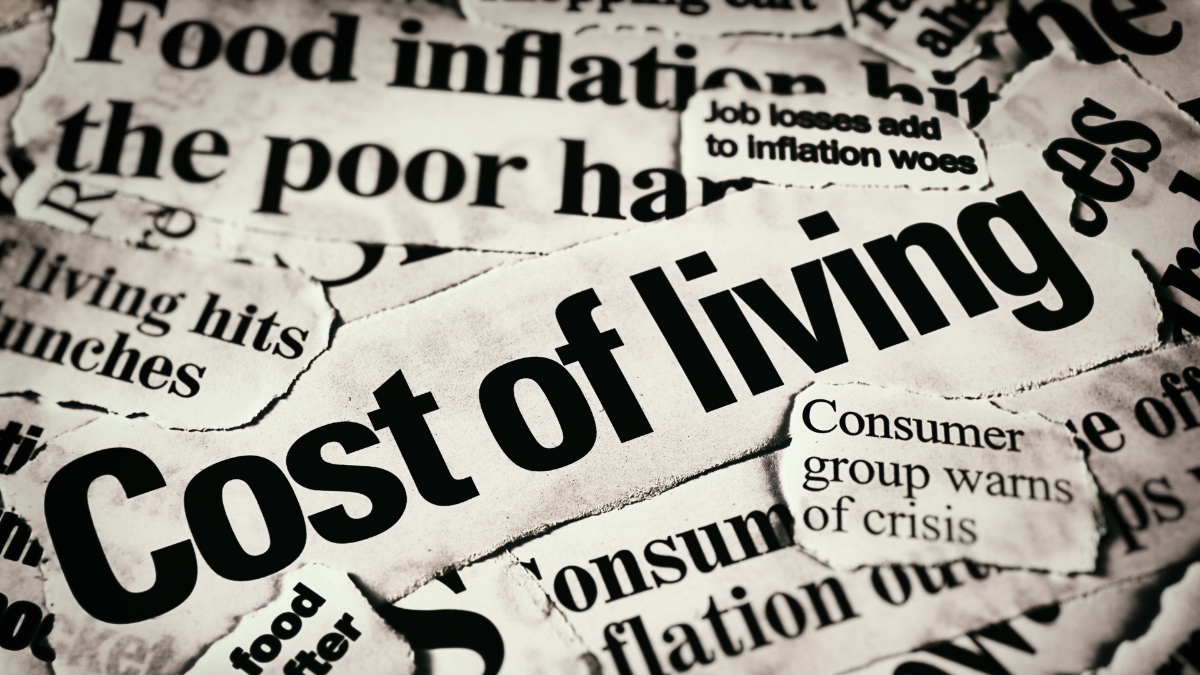 Printed newspaper headline says Cost of living