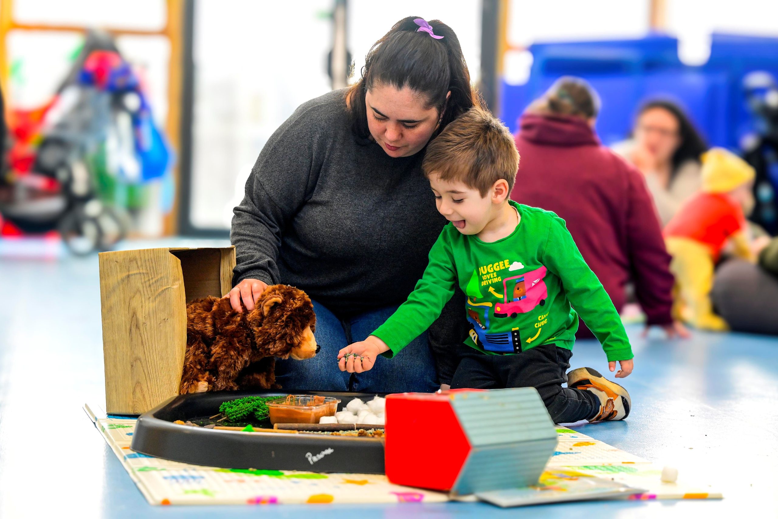Mum playing with son at a toddler group